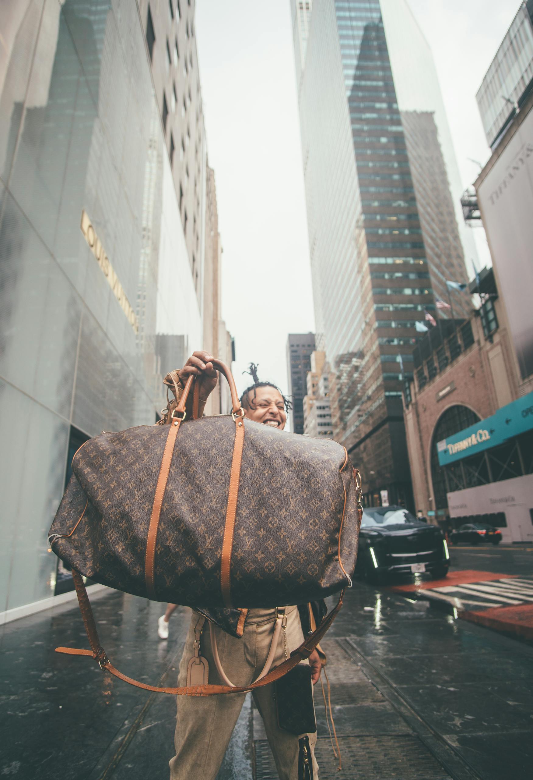 A Man Holding Brown Leather Bag