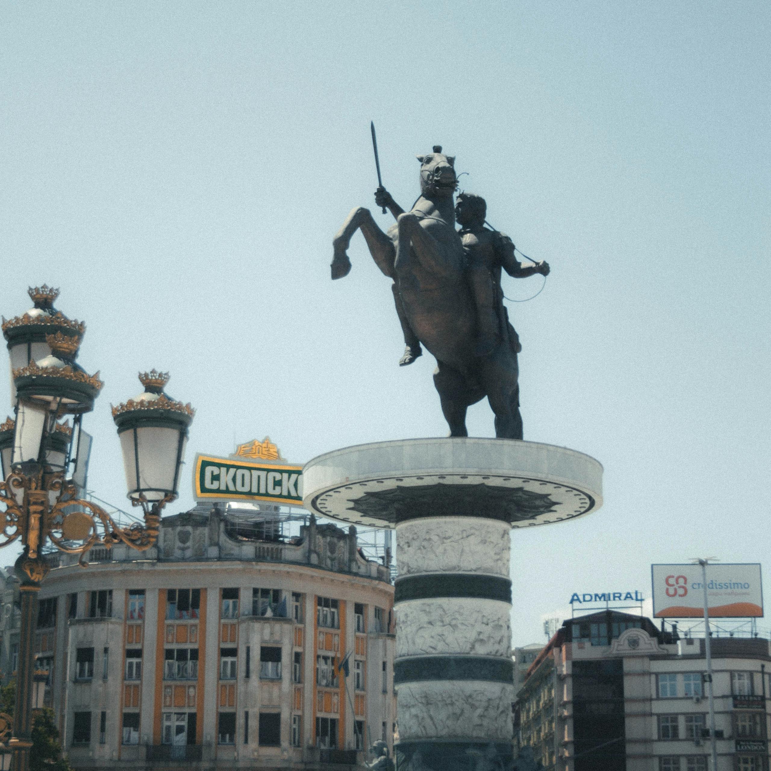 A statue of a man on a horse in the middle of a city