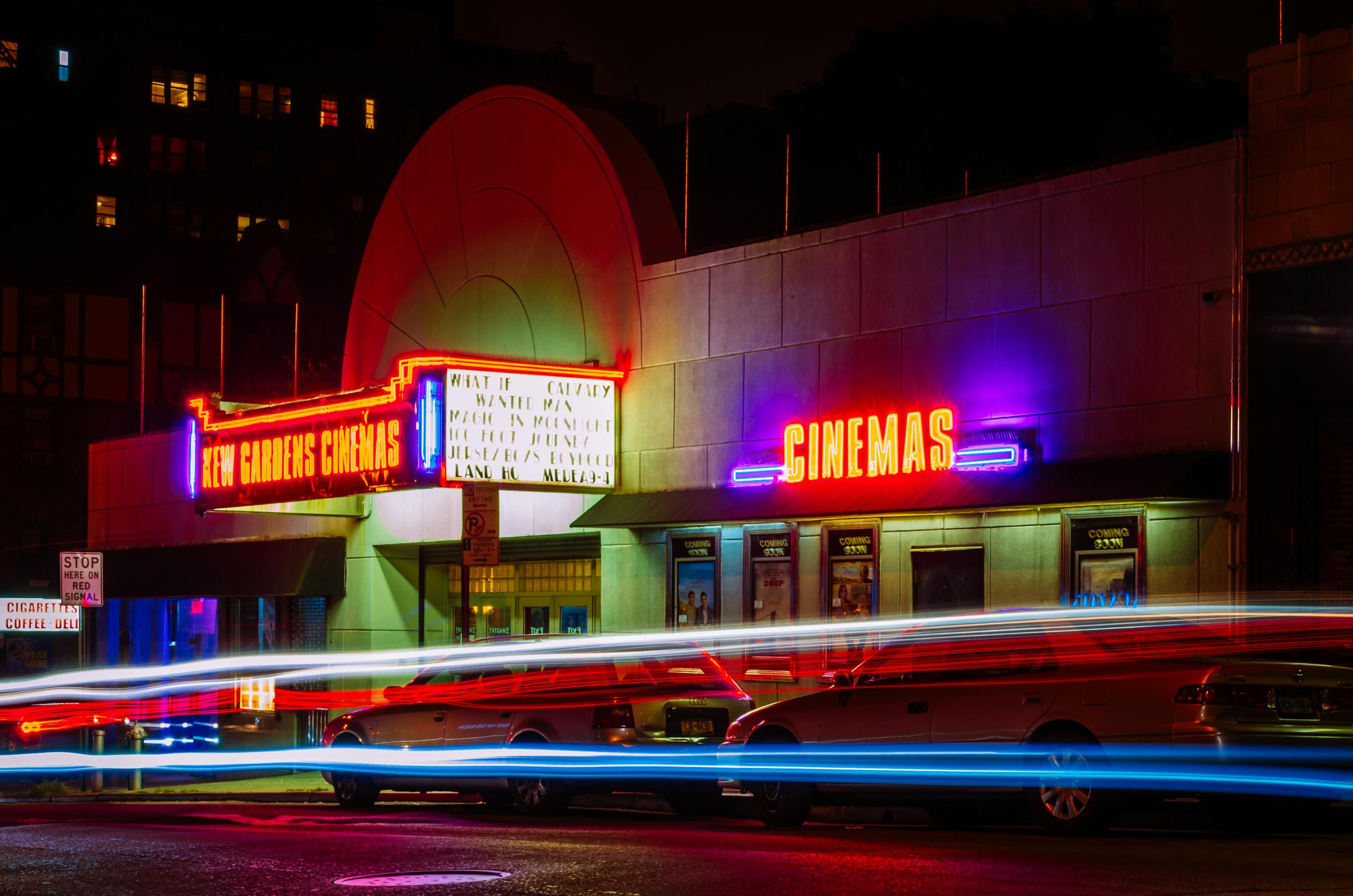 Time-lapse Photography of Car Lights in Front of Cinema